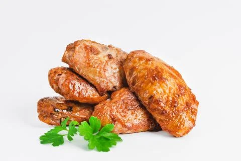 Chicken wings fried until half cooked, semi-finished product with fresh herbs on Stock Photos