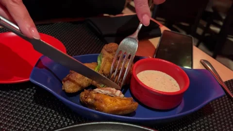 Chicken wings hand and knife cutting fried chicken cordon bleu set of plate with Stock Footage 302268472