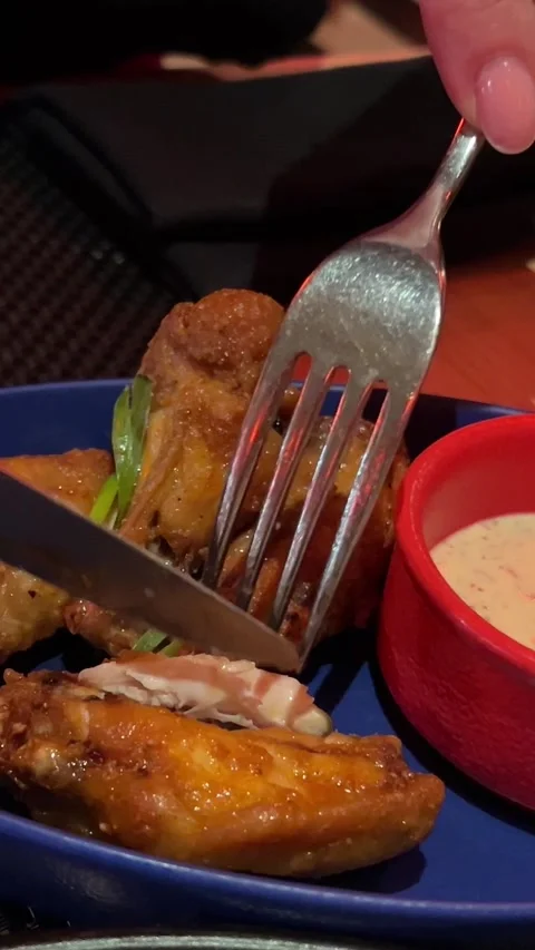 Chicken wings hand and knife cutting fried chicken cordon bleu set of plate with Stock Footage 302803490