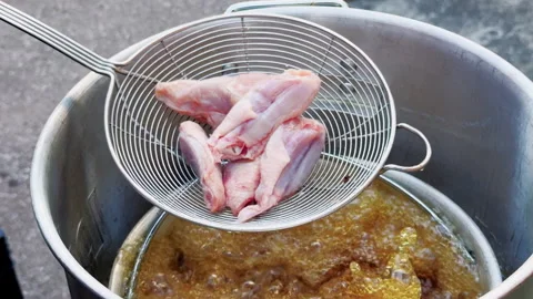 Chicken Wings Lowered Into Outdoor Deep Fryer Stock Footage 346648807