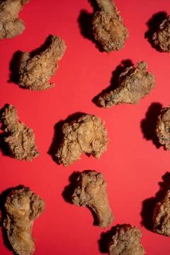 Chicken wings in pattern with red background Stock Photos