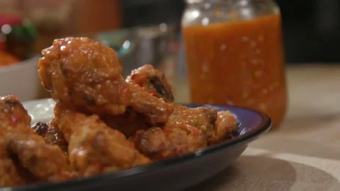 Chicken Wings rack Focus to Hot Sauce Angled Stock Footage 81276816