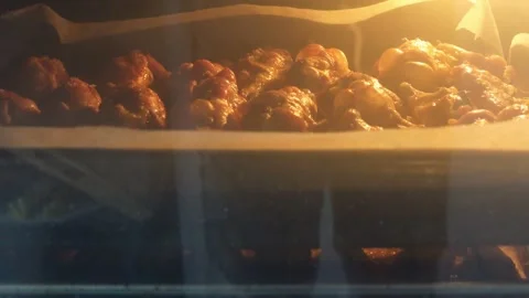 Chicken wings roasting inside an oven Stock Footage 296488061