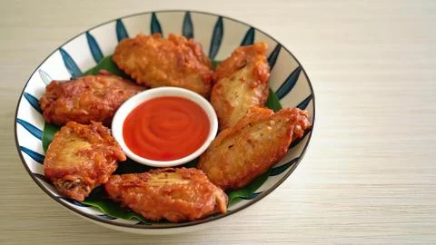 Chicken wings with sauce on a patterned plate 写真素材