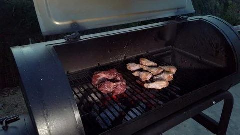 Chicken Wings on the Summer BBQ. But do not forget those Pieces of Hanging Stock Footage 108463678