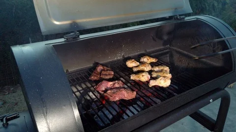 Chicken Wings on the Summer BBQ. But do not forget those Pieces of Hanging Stock Footage 108463701