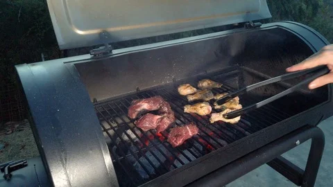 Chicken Wings on the Summer BBQ. But do not forget those Pieces of Hanging Stock Footage 108463718