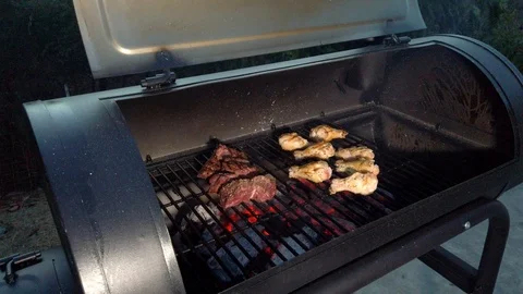 Chicken Wings on the Summer BBQ. But do not forget those Pieces of Hanging Stock Footage 108463729