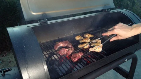 Chicken Wings on the Summer BBQ. But do not forget those Pieces of Hanging Stock Footage 108463761