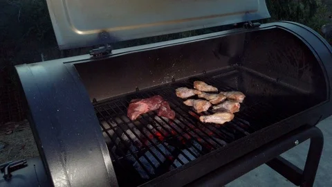 Chicken Wings on the Summer BBQ. But do not forget those Pieces of Hanging Stock Footage 108463764