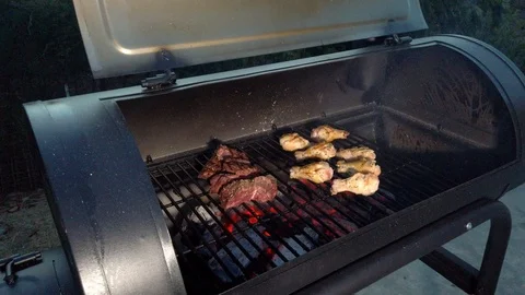 Chicken Wings on the Summer BBQ. But do not forget those Pieces of Hanging Stock Footage 108463822