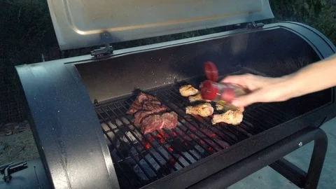 Chicken Wings on the Summer BBQ. But do not forget those Pieces of Hanging Stock Footage 108468130