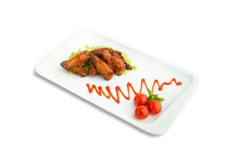 Chicken wings with tomatoes Stock Photos