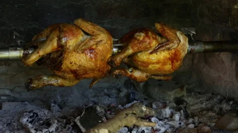 Тhe chickens are turned on a spit, baked on fire of wood and charcoal. Stock Footage 162463963