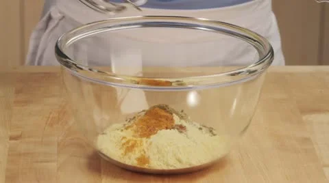 Chickpea batter being made: chickpea flour and spices being mixed with water Stock Footage 24671933