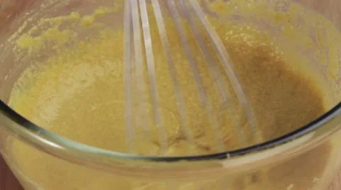 Chickpea batter being mixed with a whisk Stock Footage 24671944