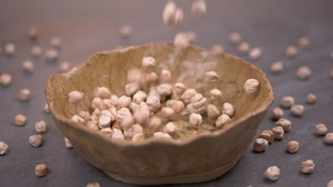 Chickpea beans falling to bowl in slow motion Stock Footage 140664901