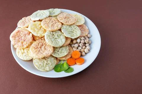 Chickpea chips snack with vegetables on a brown background Stock Photos