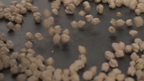 Chickpea falling on table surface Slow motion Stock Footage 107940992