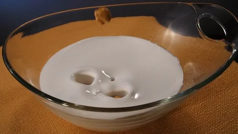 Chickpeas fall into milk in slow motion Stock Footage 112887575