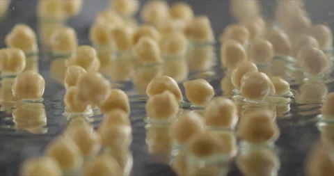Chickpeas fall on a mirror surface Stock Footage 197865875