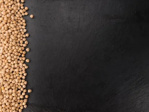 Chickpeas on a slate slab, selective focus Stock Photos
