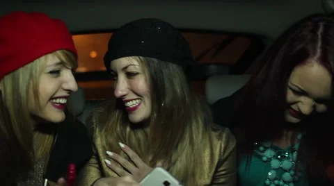 Chicks talking, laughing and making a selfie in the back of a cab Stock Footage 60183591