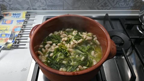 Chicory and bean soup cooked in a terracotta pan (2) Stock Footage 292414549