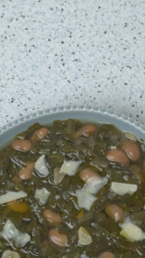 Chicory and bean soup. Copy space. Vertical video. Stock Footage 311799671