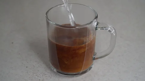 Chicory drink being made in transparent mug Stock Footage 104492983