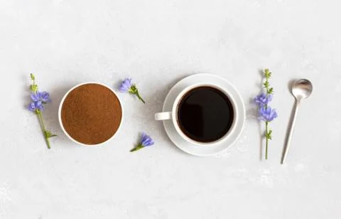 Chicory drink, ground chicory root and blue flowers on a white background.  Stock Photos