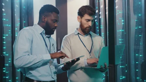 Chief administrator cooperating with african server technician inspecting open Video stock 119232588