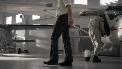 Chief aviation engineer walking through airport hangar Stock Footage 104871808