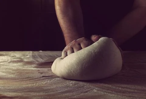 Chief baker preparing dough for bread in a bakery. Kitchen professional. Foto stock