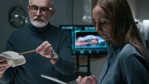 Chief Car Engineer Discussing Reference Vehicle Model with Young Colleague Video stock 304421306
