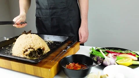 Chief cook is breaking salt and carving fish baked in salt crust. Stock Footage 147940970