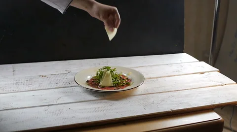 Chief cook decorating dish in restaurant on background Stock Footage 67747137
