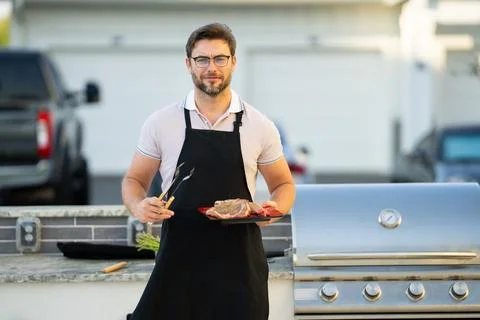 Chief cook with utensils for barbecue grill. Stock Photos