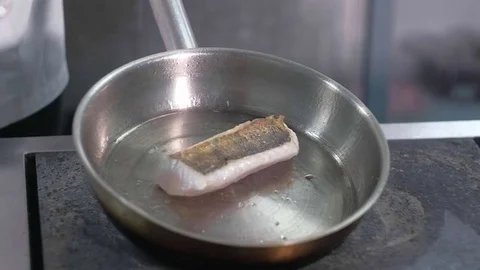 The chief cooks a fish in a restaurant Stock Footage 83302286