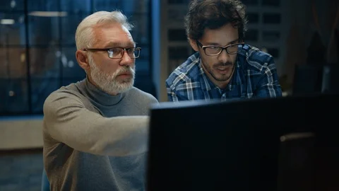 Chief Creative Designer Shows Desktop Computer Screen to a Young Developer Video stock 111332149