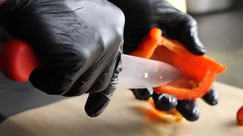 The chief is cutting peppers for the burger. Stock Footage 86177802