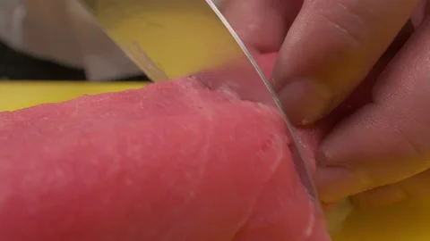 Chief is cutting ready sushi roll using knife Stock Footage 212843139