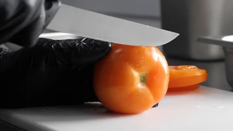 The chief is cutting tomatoes for the burger Stock Footage 86178314