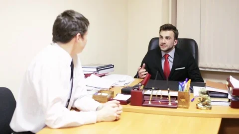 The chief discusses the project with the employee Stock Footage 75779555