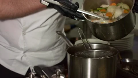 The chief drains the broth. Close up Stock Footage 131152065