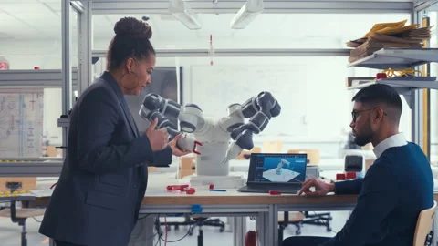 Chief Engineer And Young Specialist Analyse Robotic Arm Stock Footage 187556957