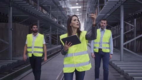 Chief engineer explaining factory work process to two new employees Stock Footage 108455677