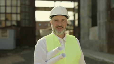 Chief engineer holding work blueprints at building object Stock Footage 198355065