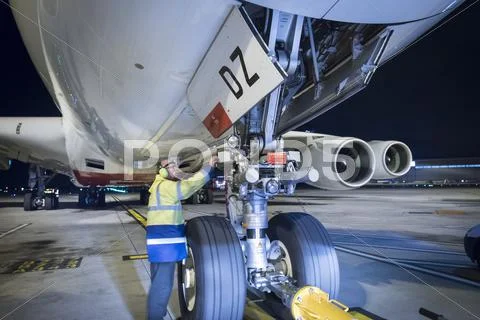 Chief Engineer Inspecting A380 Aircraft On Runway At Night