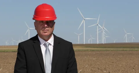 Chief Engineer Man Looking Camera Wind Turbines Farm Green Energy Windmills Spin 스톡 동영상 54539405